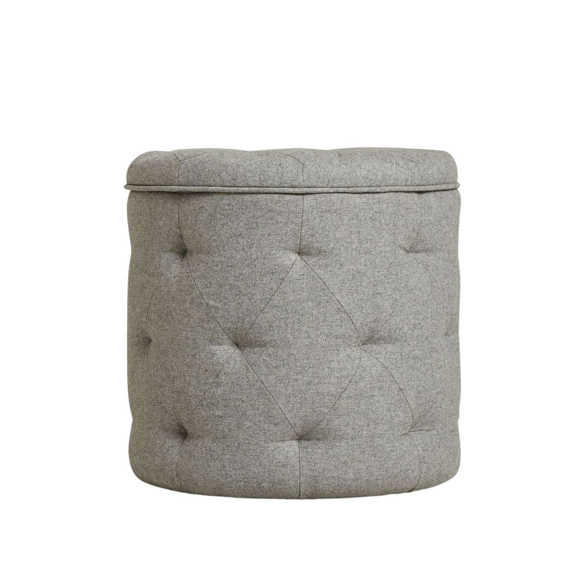 Gray tufted ottoman on a white background