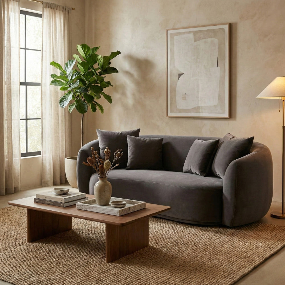 Living room with a gray sofa, wooden coffee table, and decorative elements.