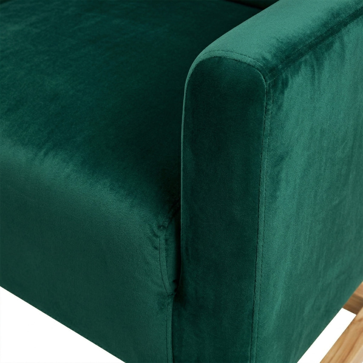 Close-up of a green velvet armchair corner