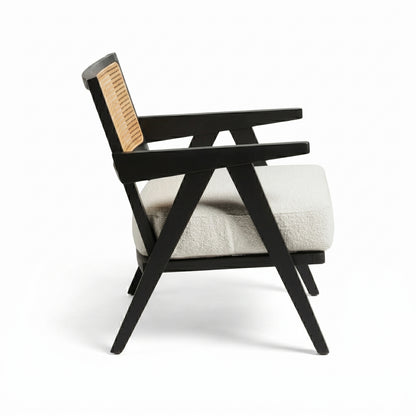 Chair with black frame and beige cushion on a white background