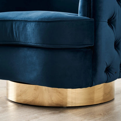 Navy blue velvet armchair with a gold base on a wooden floor.