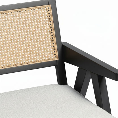 Chair with black frame, woven backrest, and gray cushion on a white background