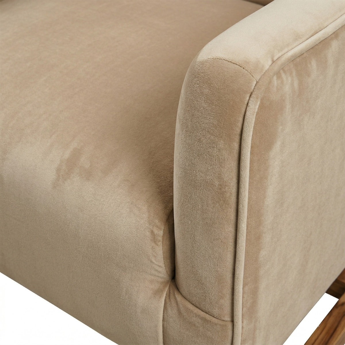 Close-up of a beige upholstered chair corner with a visible stain.