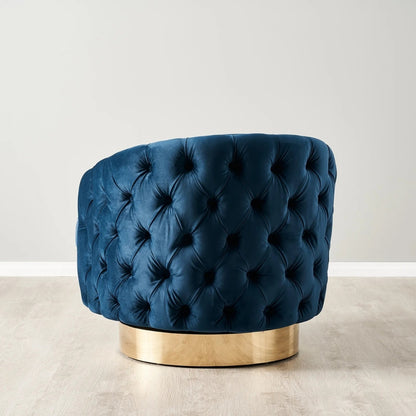 Blue tufted chair with gold base on a light background