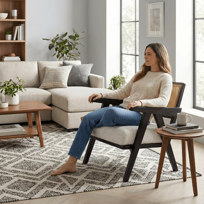 Woman sitting in a modern living room with a neutral color scheme.