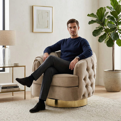 Man sitting in a beige armchair in a modern living room with a plant and side table.