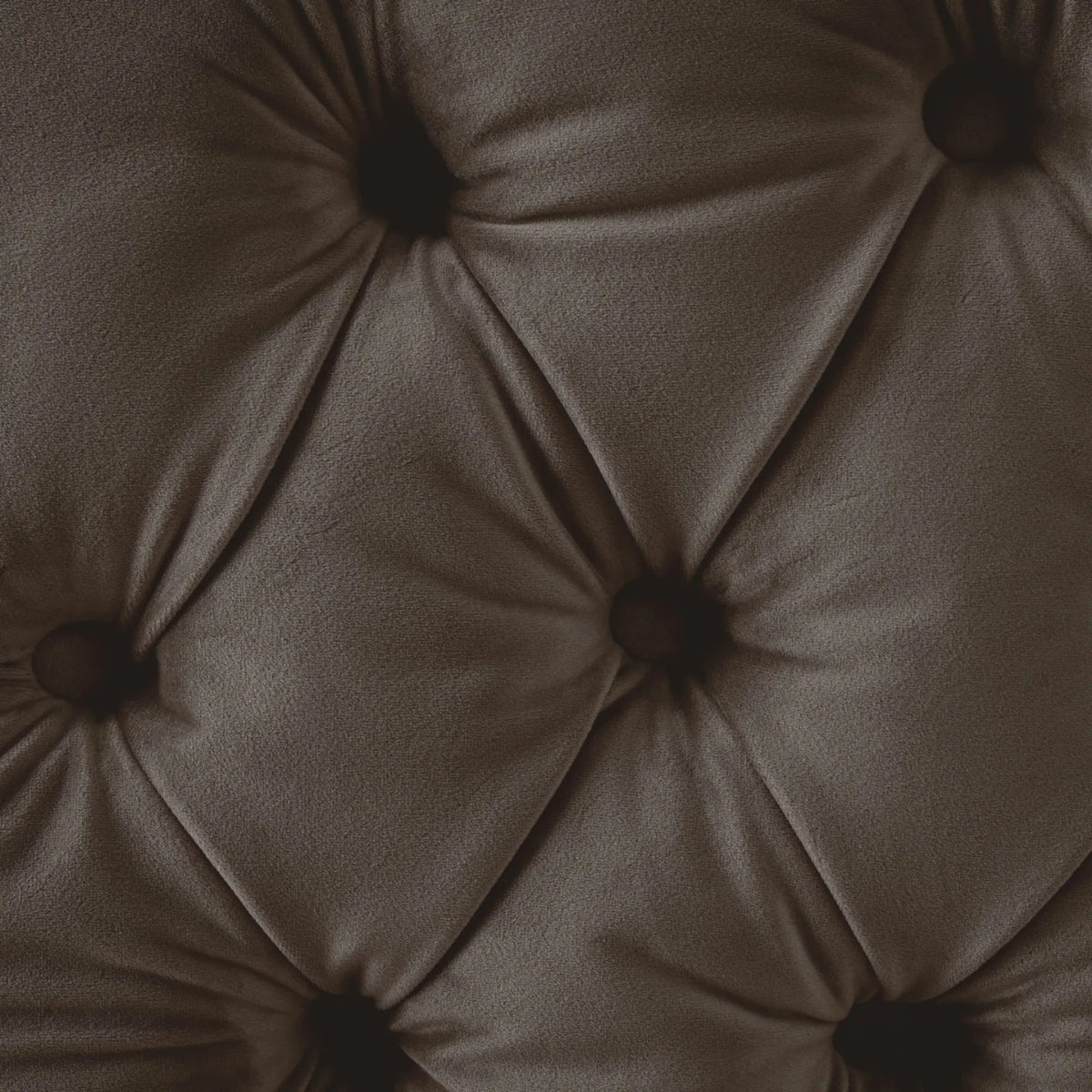 Close-up of a brown tufted cushion with button details