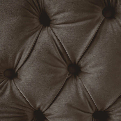 Close-up of a brown tufted cushion with button details