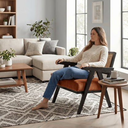 Woman sitting in a modern living room with a neutral color scheme.