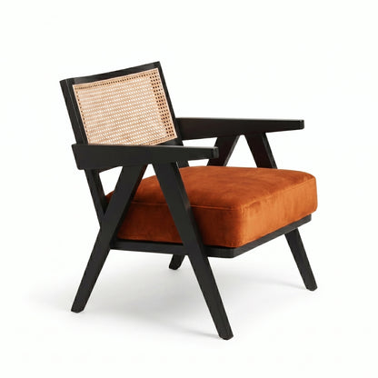 Chair with black frame, orange cushion, and woven backrest on a white background