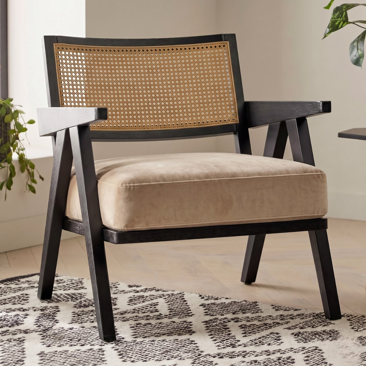 Chair with wicker backrest and beige cushion on a patterned rug