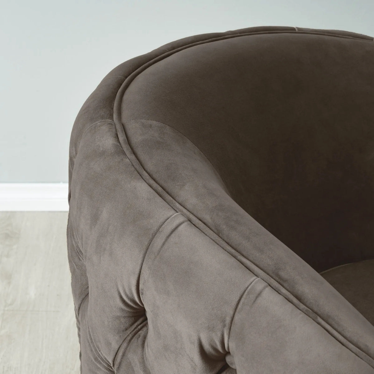 Close-up of a brown upholstered chair with a neutral background