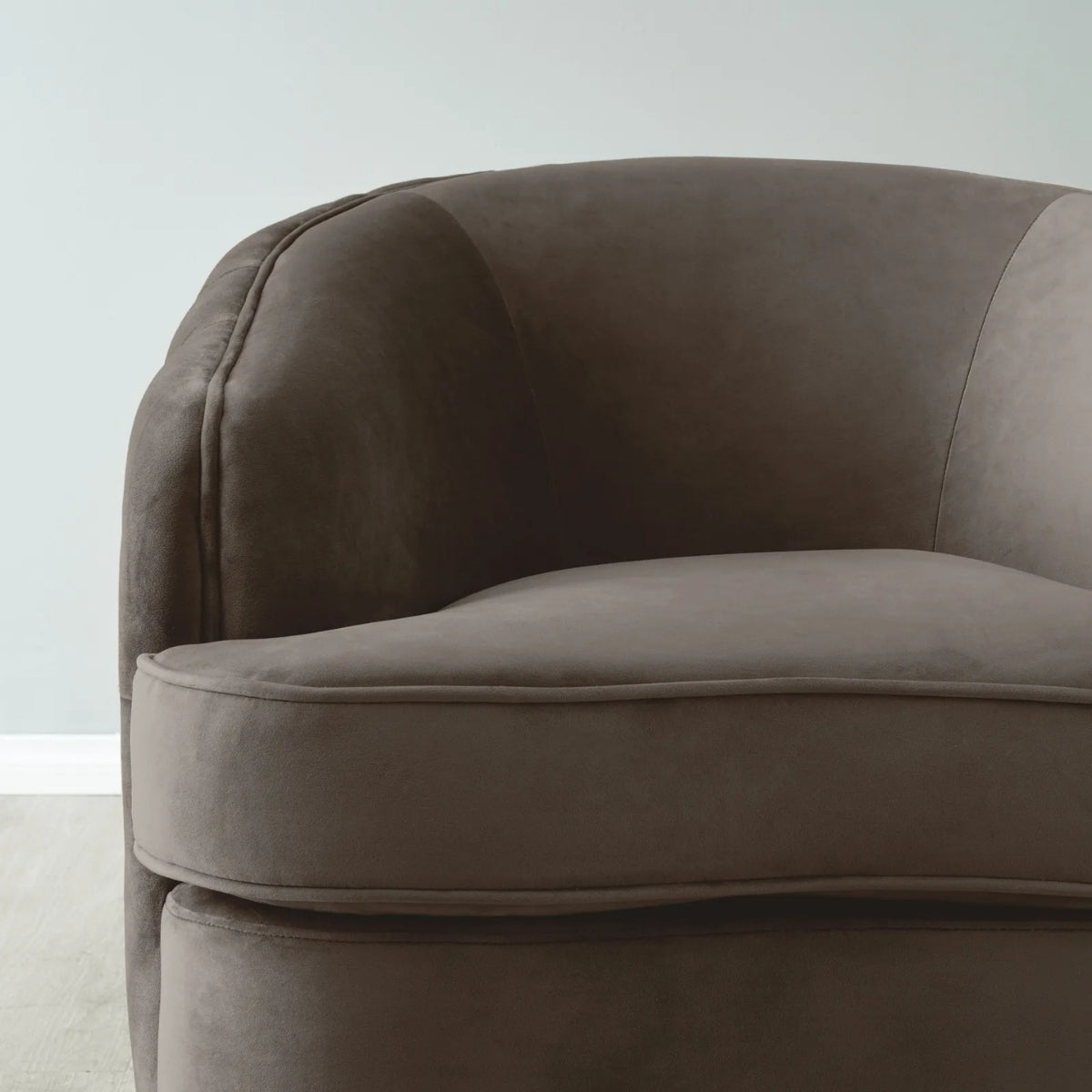 Brown upholstered chair against a light gray background