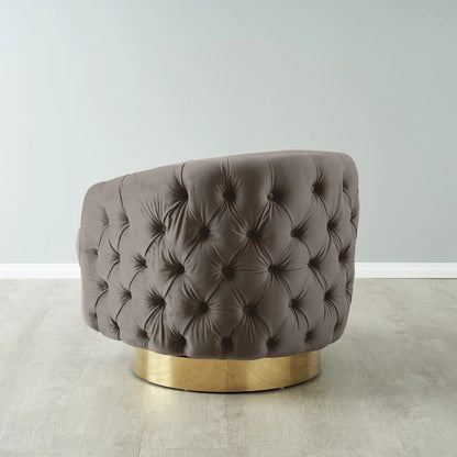 Brown tufted chair with gold base on a light wooden floor.
