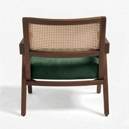 Wooden armchair with wicker backrest and green cushion on a white background