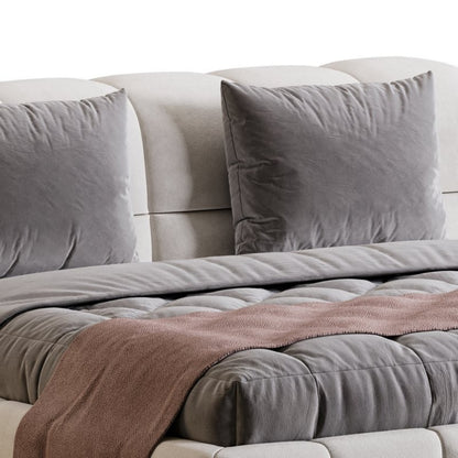 Gray sofa with cushions and a blanket on a white background