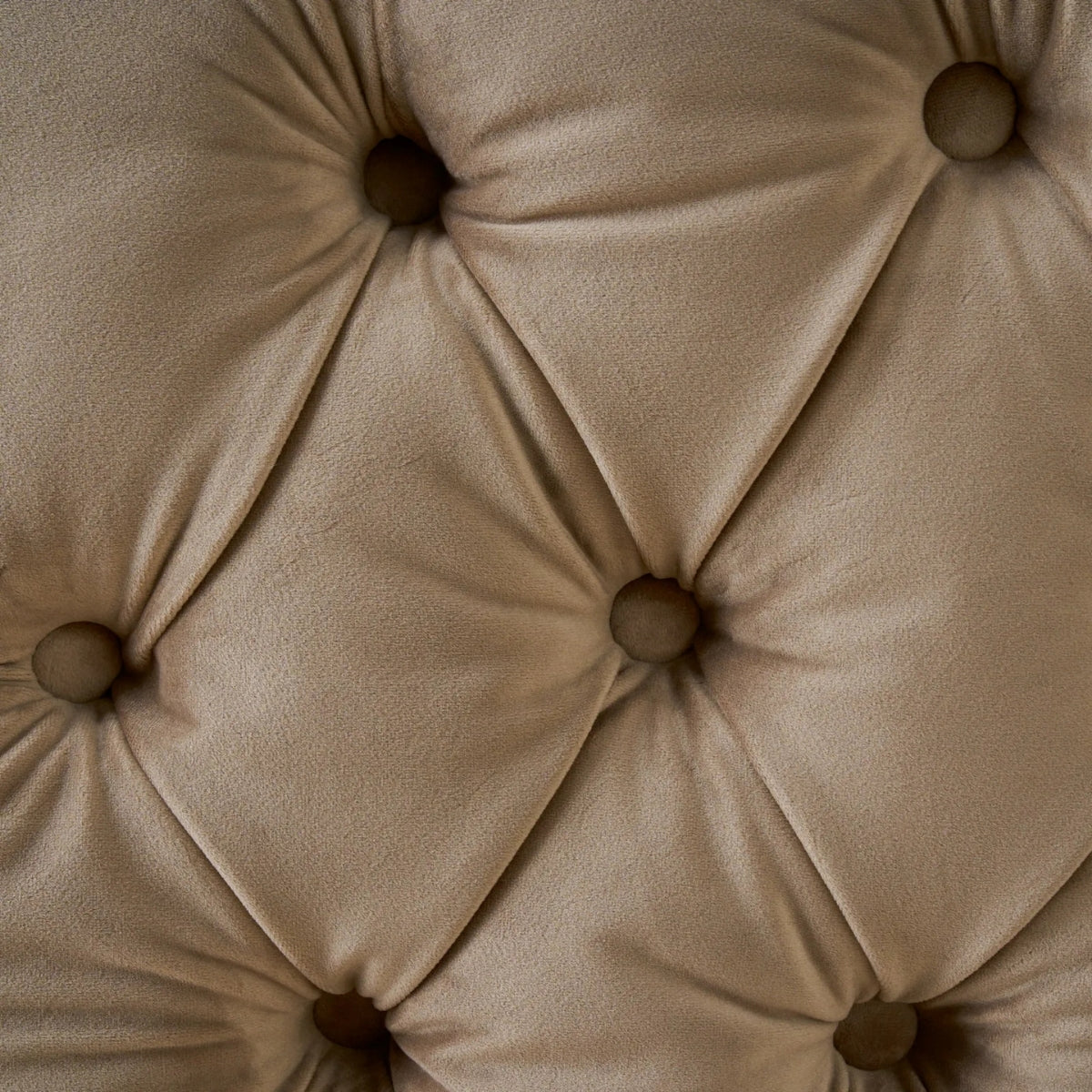 Close-up of a beige tufted cushion with button details