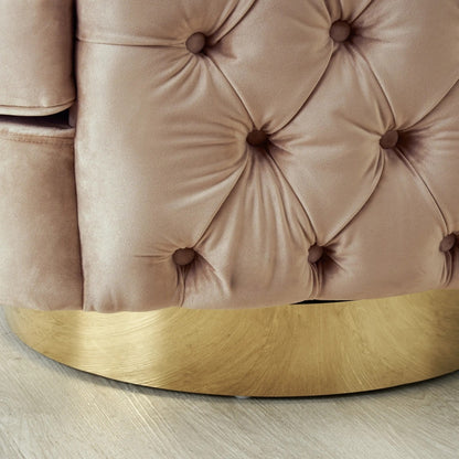 Close-up of a tufted pink velvet chair with a gold base on a light wooden floor.