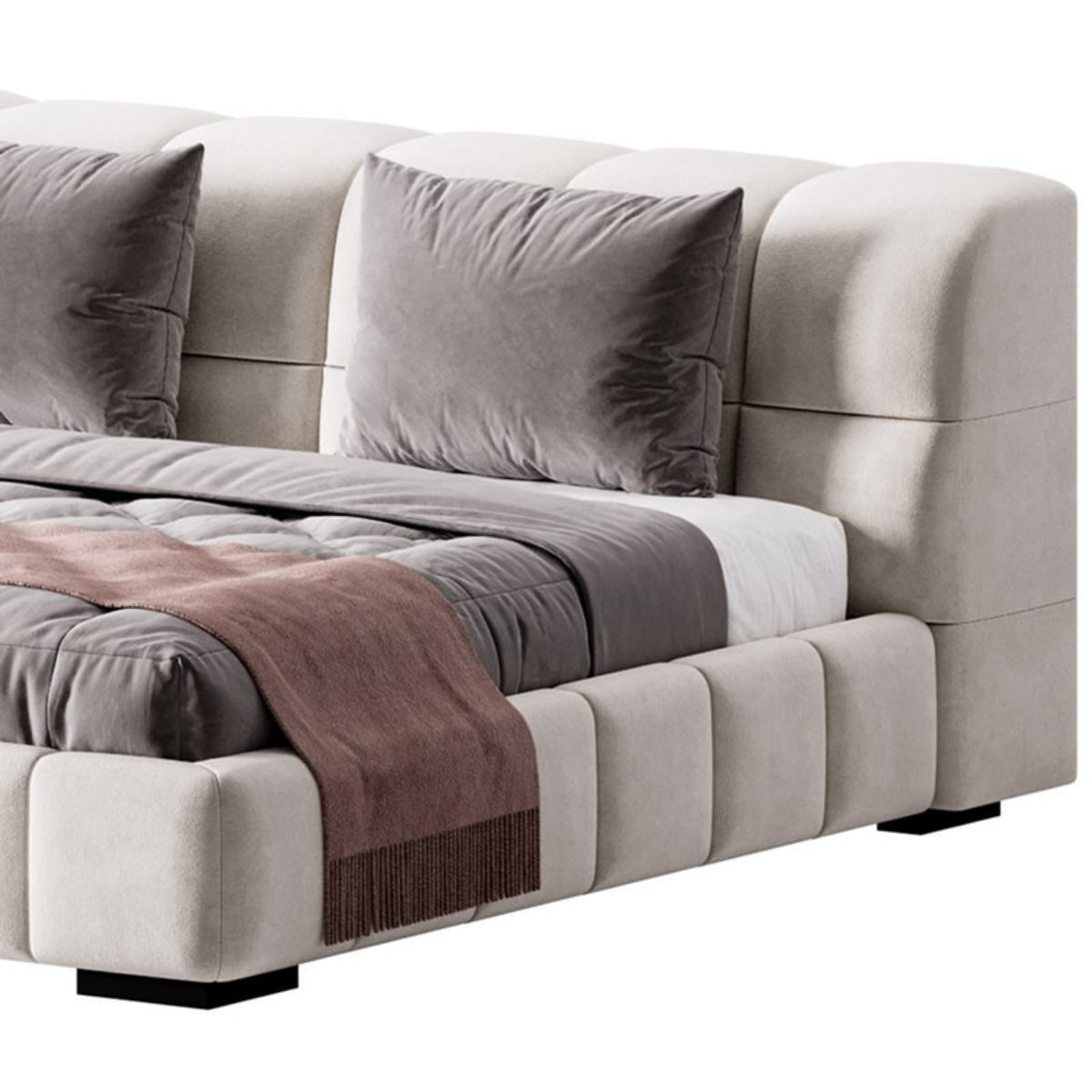 Gray sectional sofa with cushions and a blanket on a white background