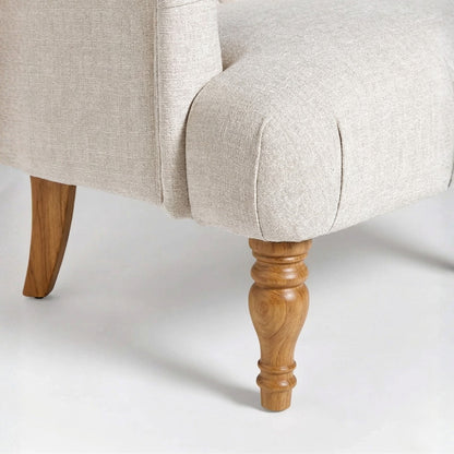 Close-up of a beige upholstered chair with wooden legs on a white background