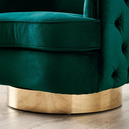 Green velvet armchair with a gold base on a wooden floor