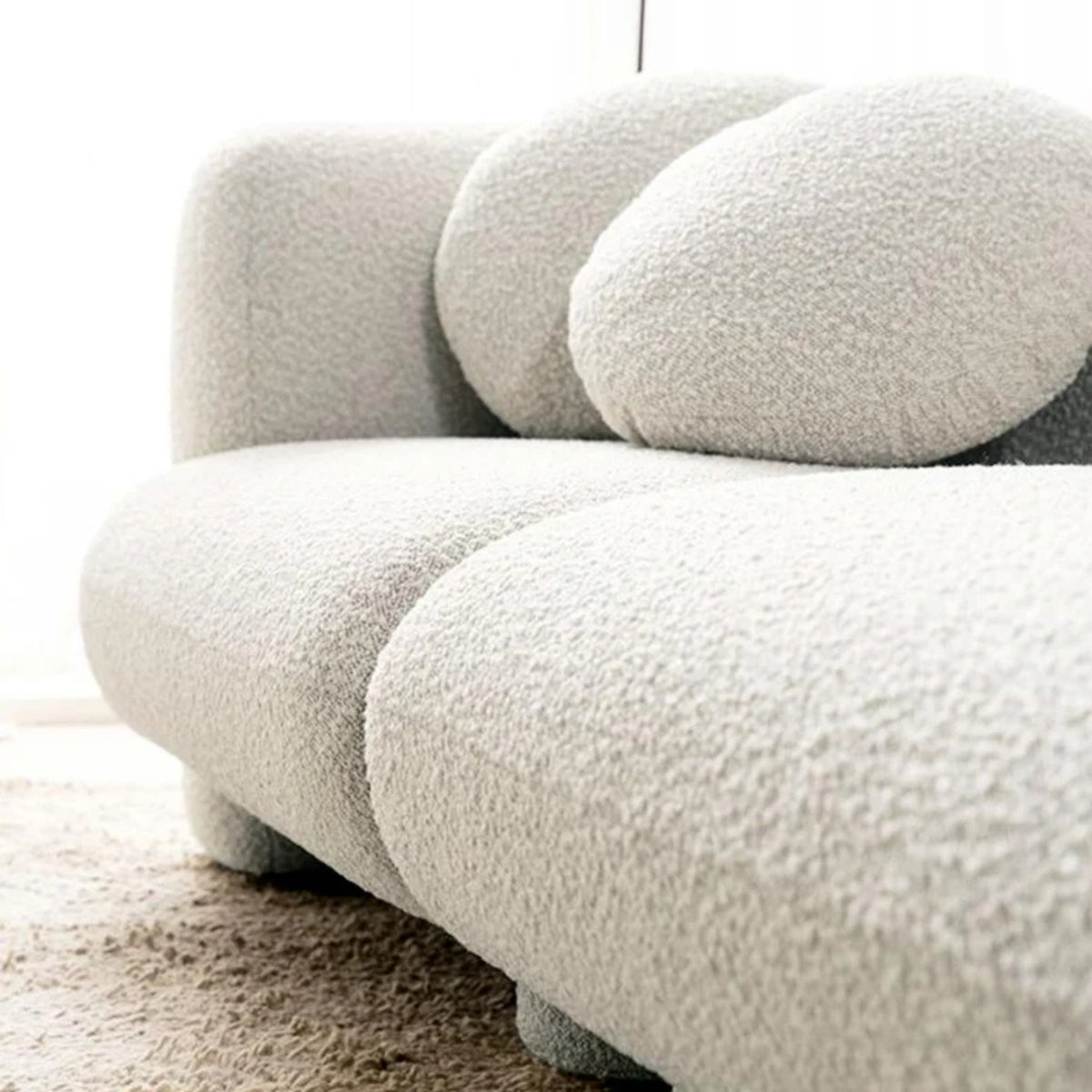 Close-up of a textured gray sofa in a minimalistic setting