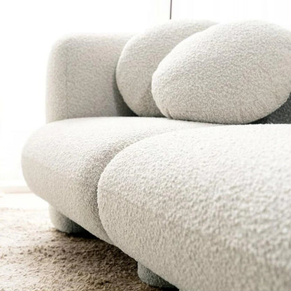 Close-up of a textured gray sofa in a minimalistic setting