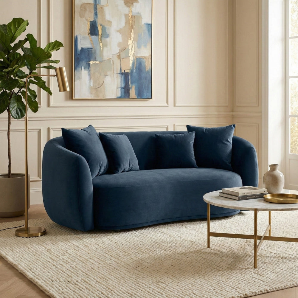 Blue sofa in a living room with abstract art and a coffee table.