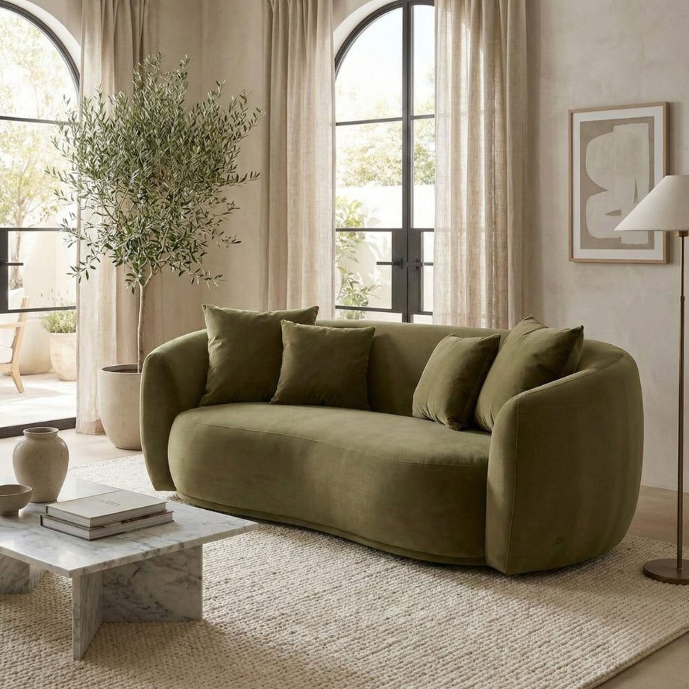 Green sofa in a living room with neutral decor