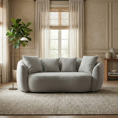 Gray sofa in a living room with a plant and window