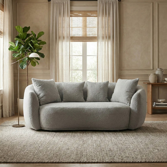 Gray sofa in a living room with a plant and window